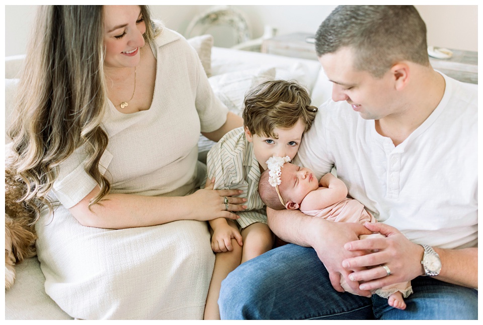 brother giving baby sister a kiss