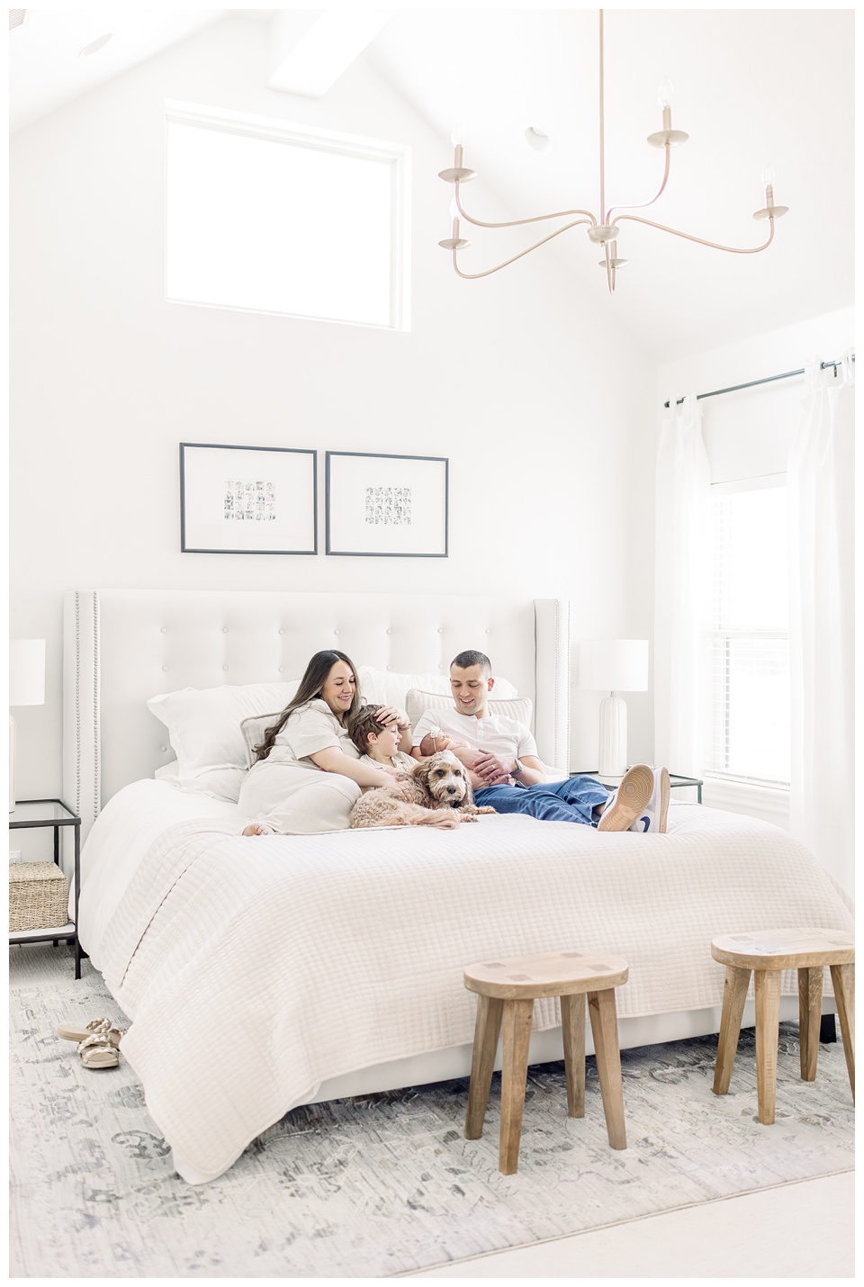 family sitting on bed for newborn session